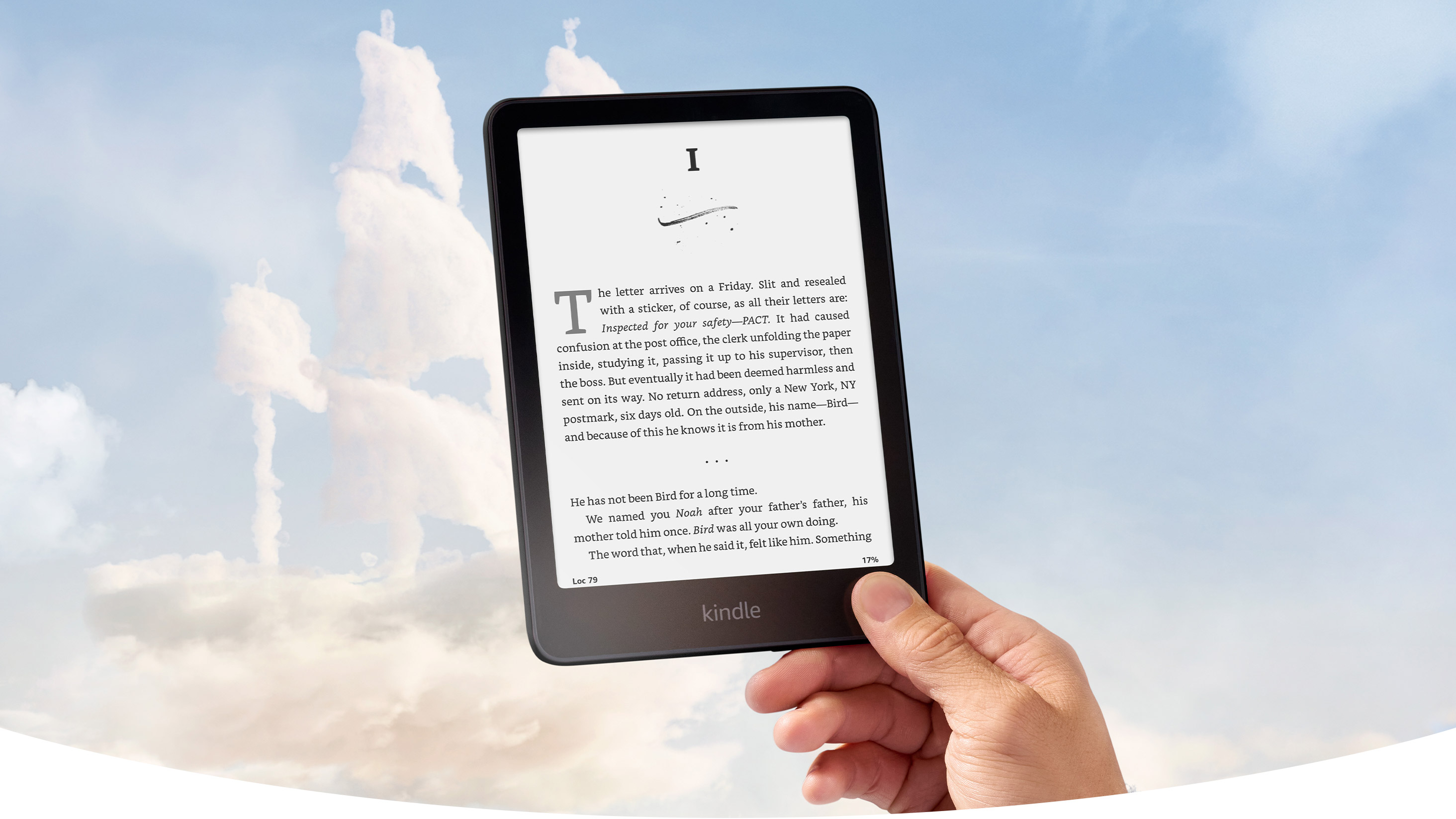 A hand holds Kindle Paperwhite Signature Edition against a blue sky. The clouds are shaped like a pirate ship. A chapter book is on screen.