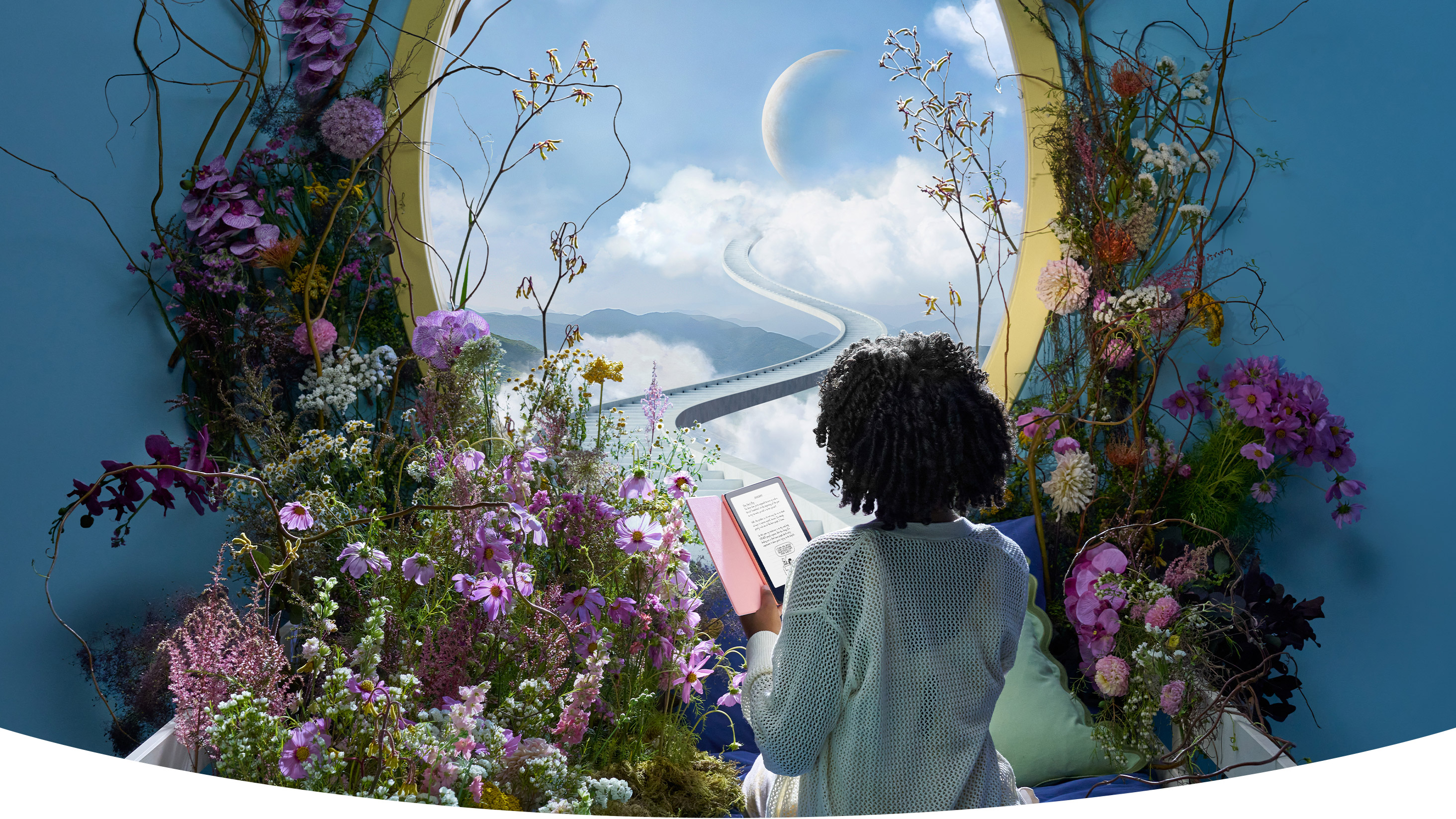Teen sits in front of a whimsically decorated window looking out to moon and clouds.