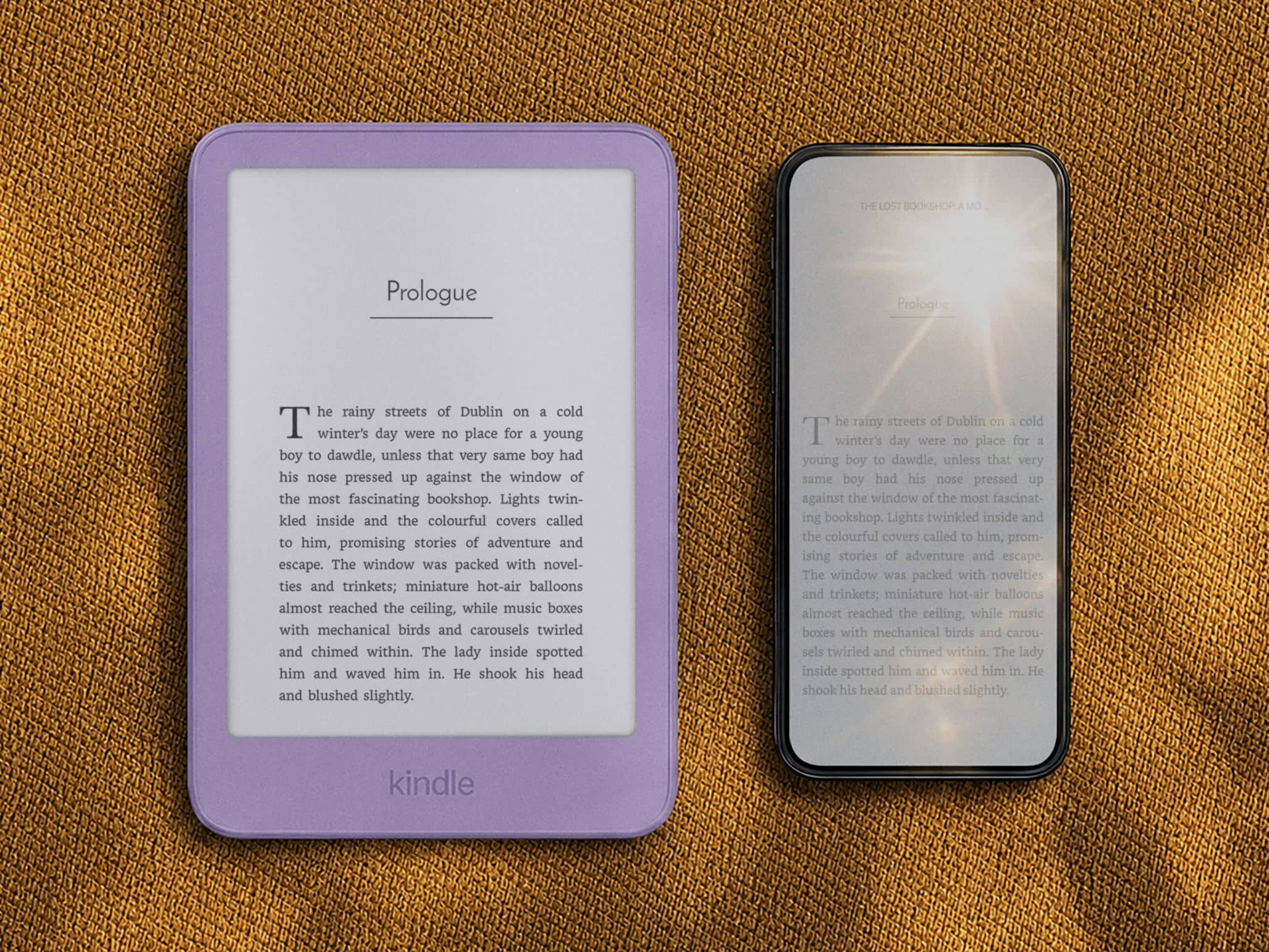 A purple Kindle and a smartphone side by side in sunlight. The Kindle's page is clear and readable, the phone's screen is washed out by glare.