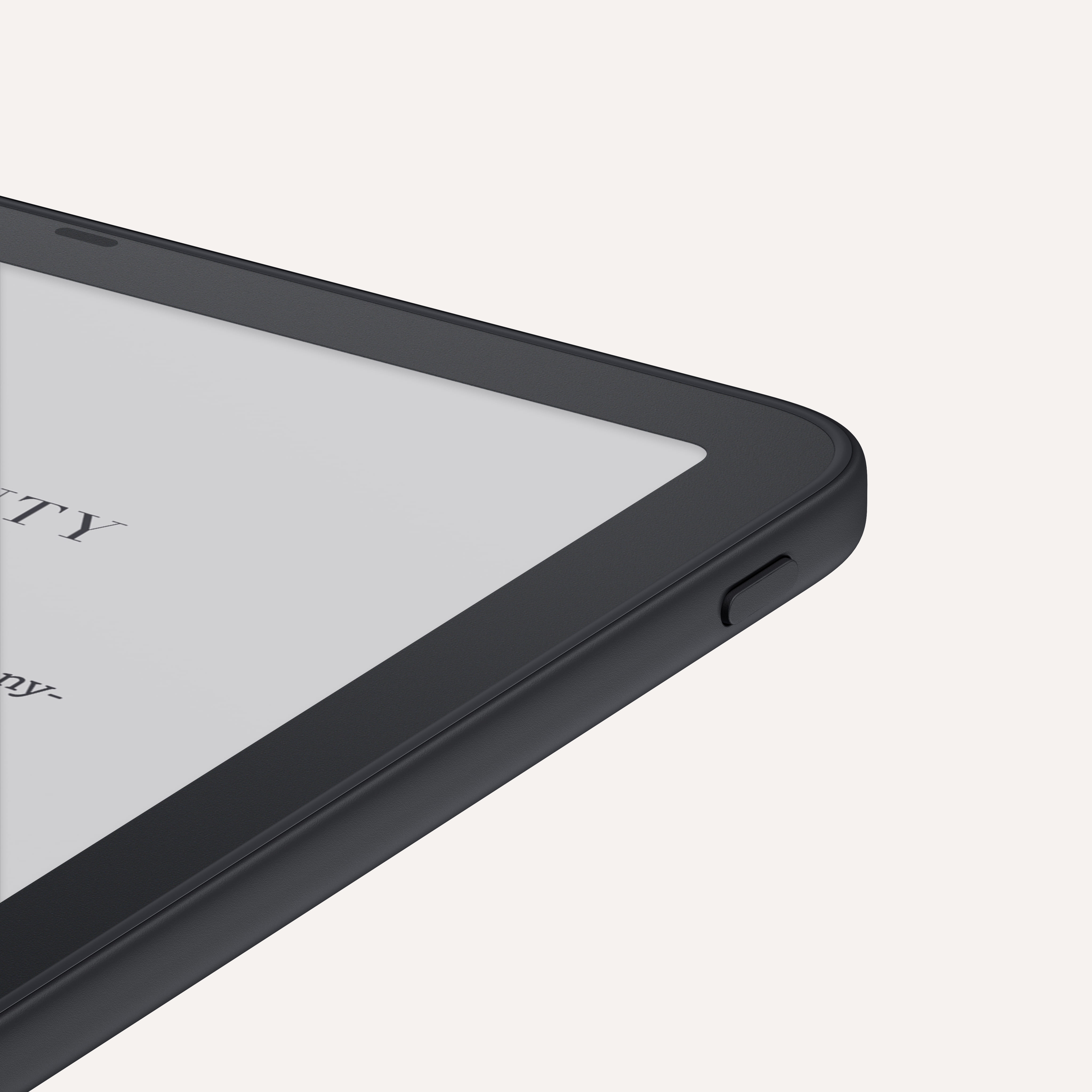 Amazon Kindle Paperwhite corner showing power button on bottom edge and rounded corners.
