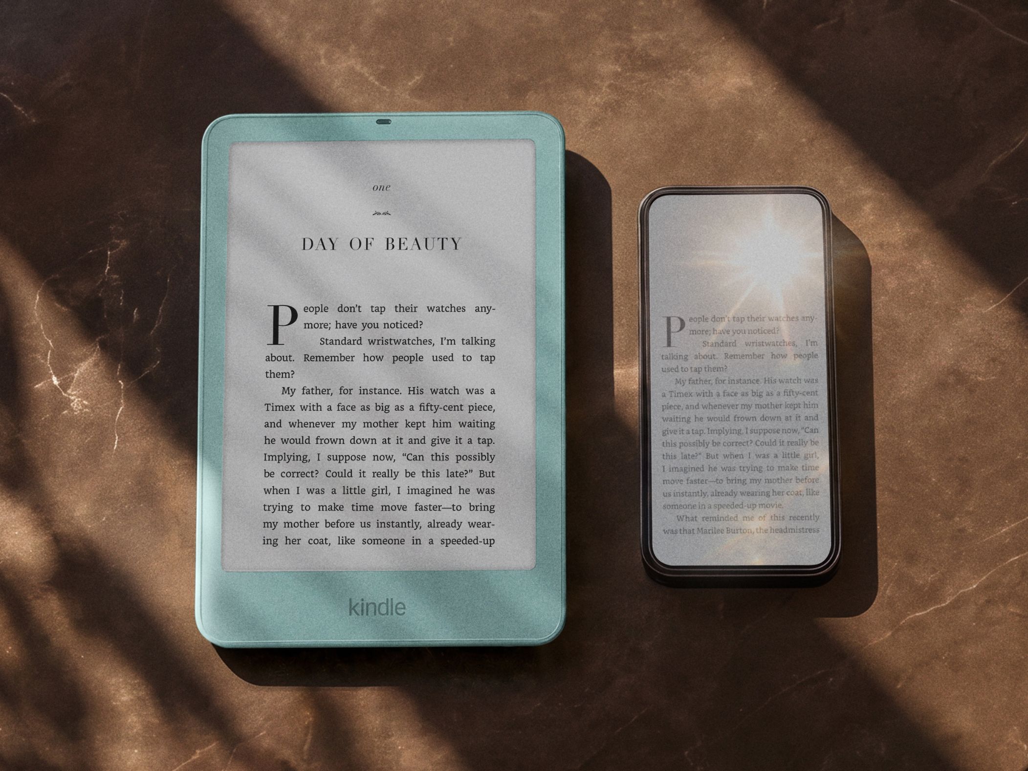 Two Amazon Kindle e-readers on a marble surface displaying the book Day of Beauty.
