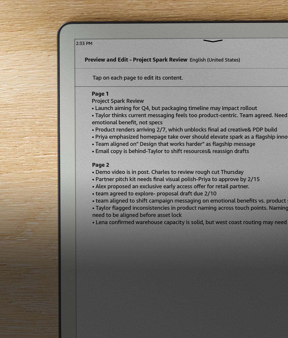 Kindle Scribe without front light on a desk showing a typed document converted from handwritten notes, pen in hand.