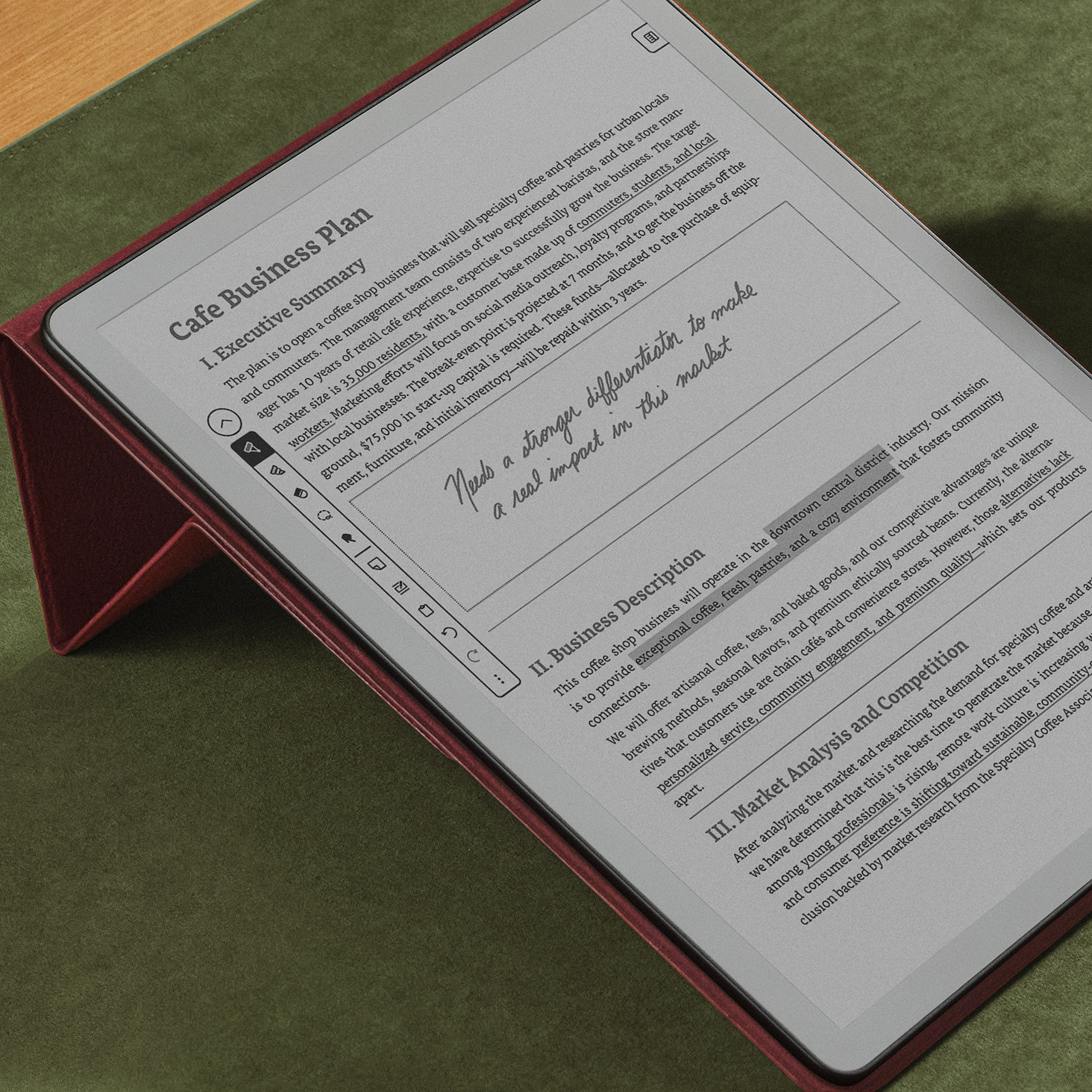 Kindle Scribe displaying a cafe business plan document with sections for Executive Summary, Business Description, and Market Analysis. Text reads: "Needs a stronger differentiation is made in this market.