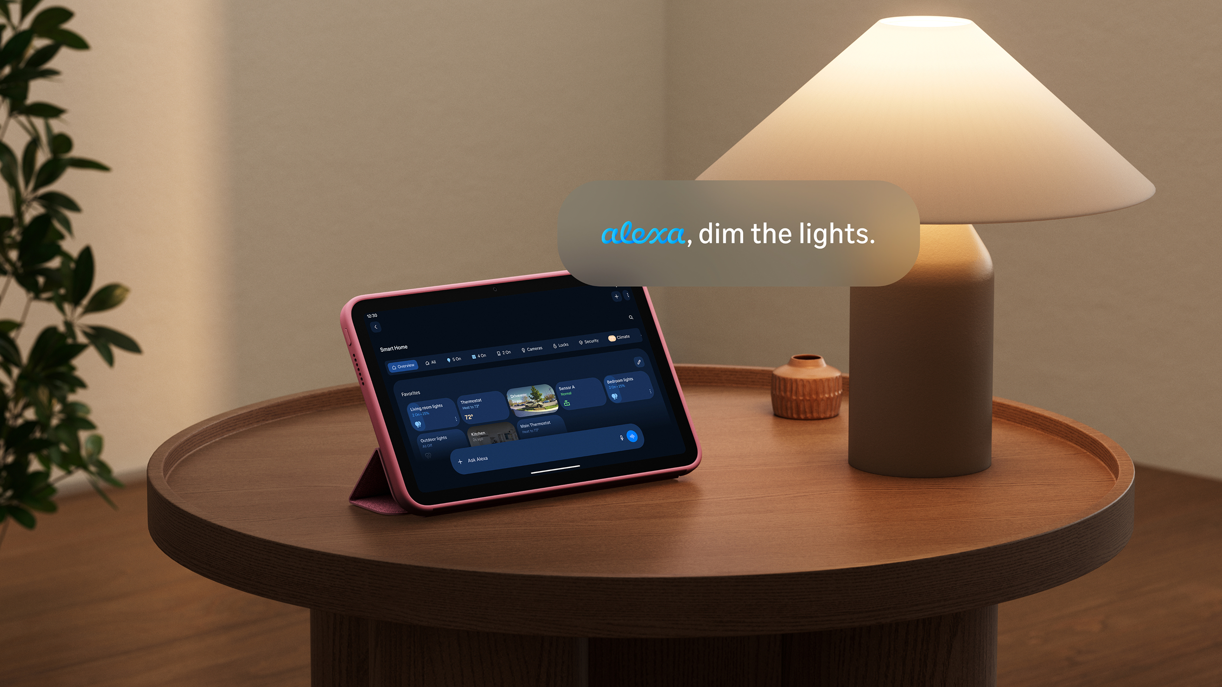 Amazon Alexa Tablet 8 on wooden table next to a lamp displaying a movie. Text reads: "Alexa, dim the lights and text Brian to stop by the store for my favorite popcorn."